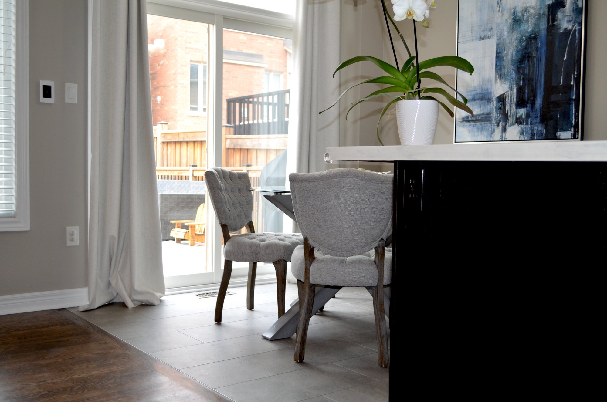 Post install shots from Laura's kitchen/dining nook with floor heating after shot of dining nook only