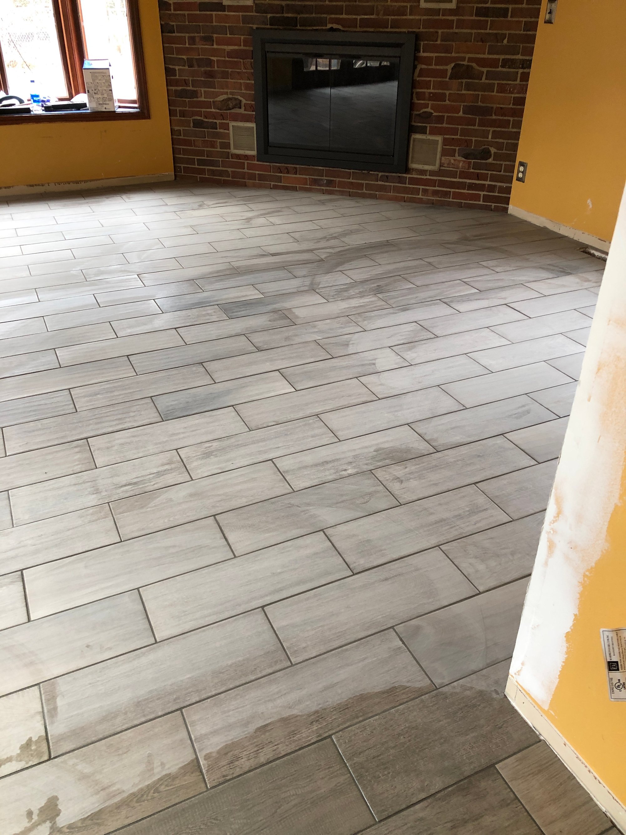 Post installation of tile floor with floor heating in living room after shot
