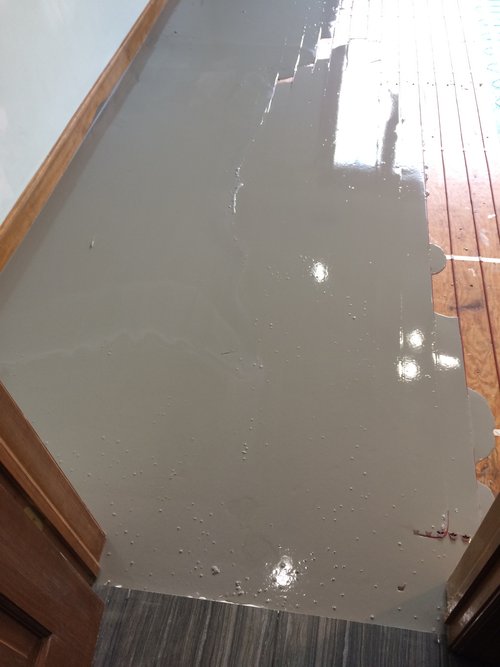 Pouring self leveling cement over floor heating system