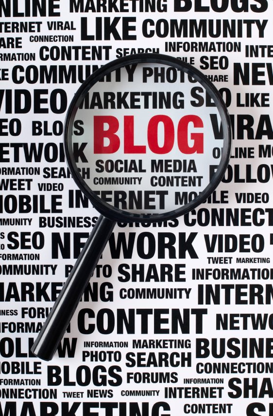 A magnifying glass focused on the word BLOG within a word cloud of digital marketing and social media terms.