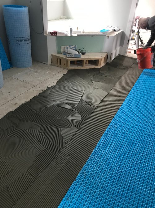 Prodeso membrane being adhered to subfloor with  thinset PERRY HALL, MD