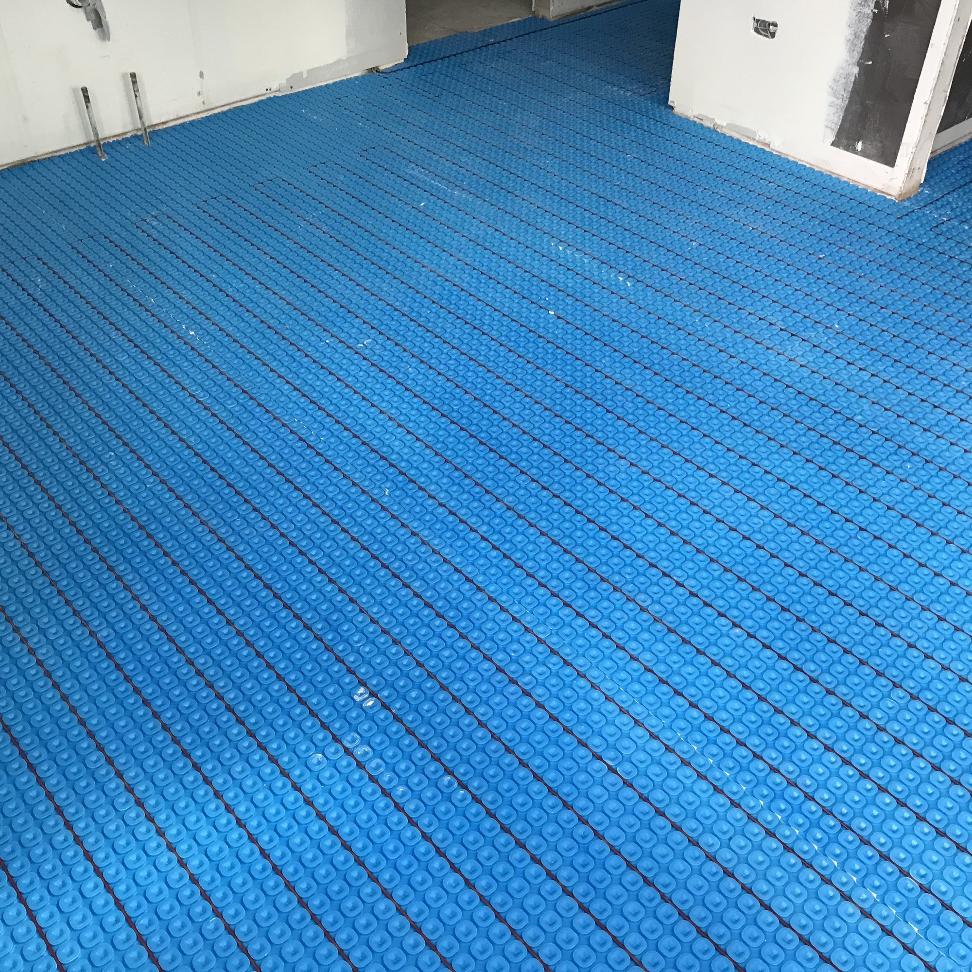 Prodeso Uncoupling Membrane Installation for Heated Tile Floors in Bathroom before flooring