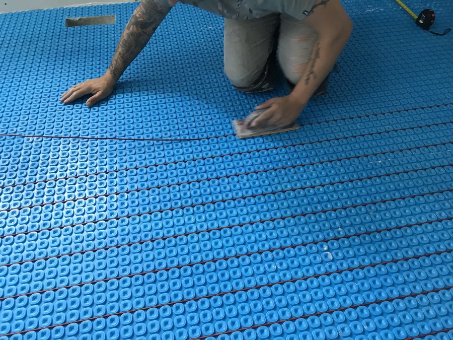 Prodeso Uncoupling Membrane Installation for Heated Tile Floors in Bathroom with float trowel