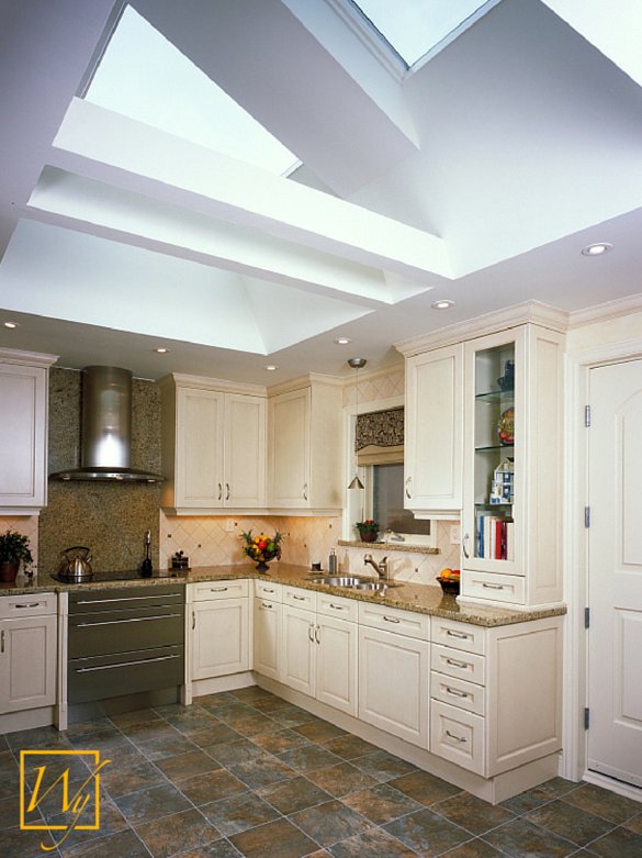 A bright kitchen with dark slate tile flooring featuring a TempZone Flex Roll electric radiant floor heating system installed underneath.