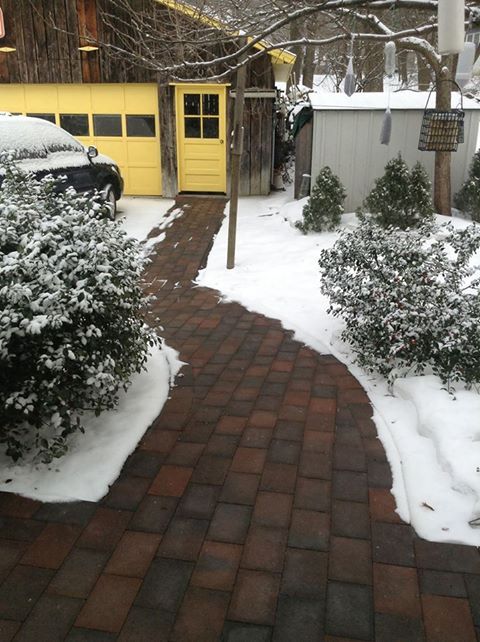 Heated paver walkway leading from garage, enabling wheelchair access during winter conditions without the need for manual snow removal.