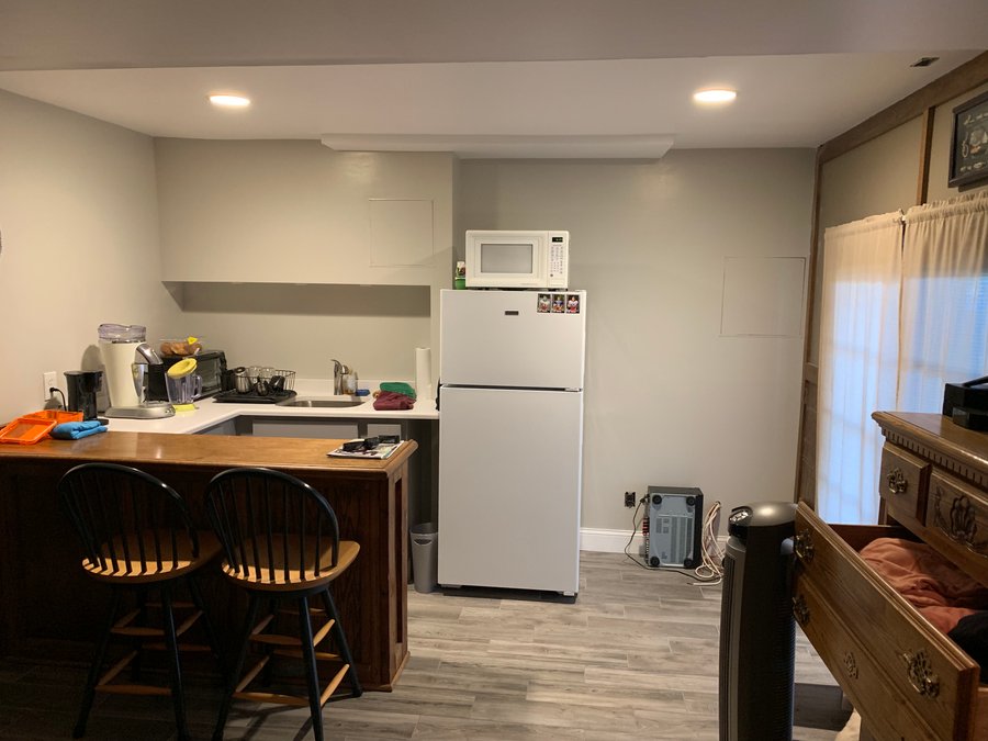 Remodeled basement kitchen with finished wood-look radiant heated flooring.