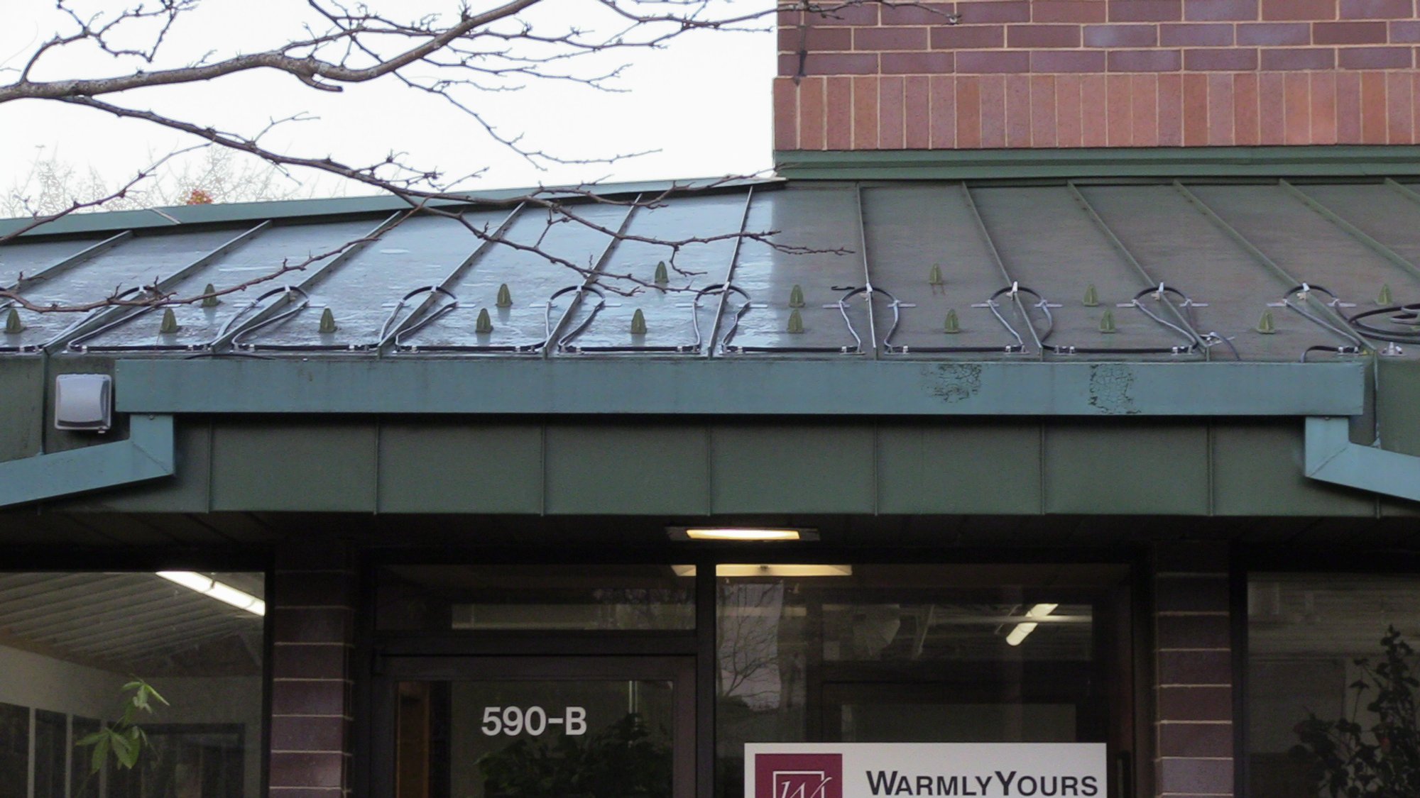 Roof and Gutter installation for WarmlyYours Office front of building