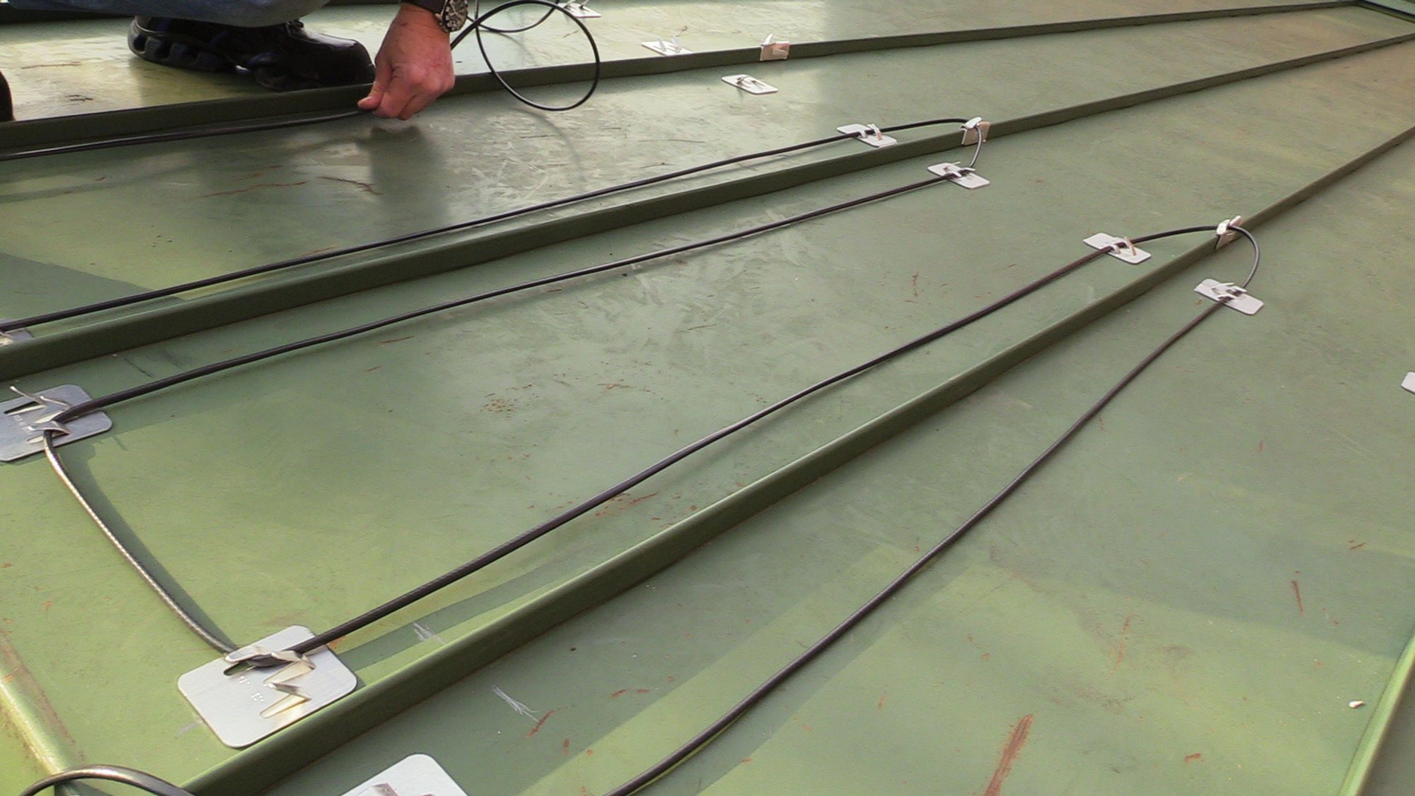 Roof and Gutter installation for WarmlyYours Office installing wire