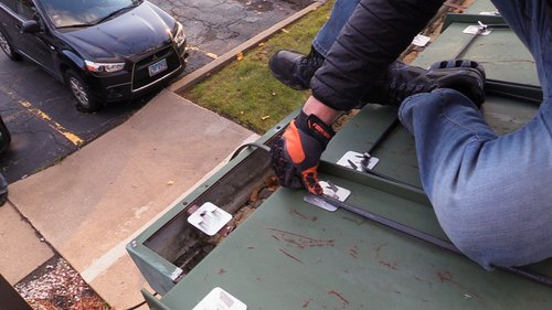 Roof and Gutter installation for WarmlyYours Office securing clip over cable