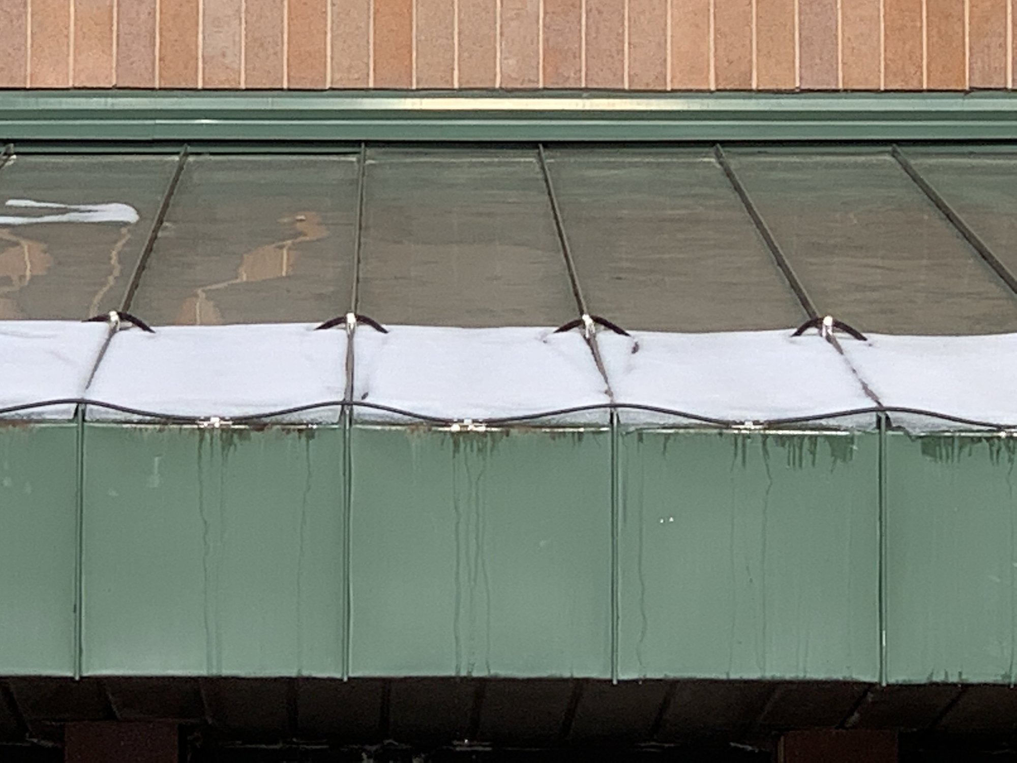 Roof and gutter installation with constant wattage top of roof at warmlyyours office