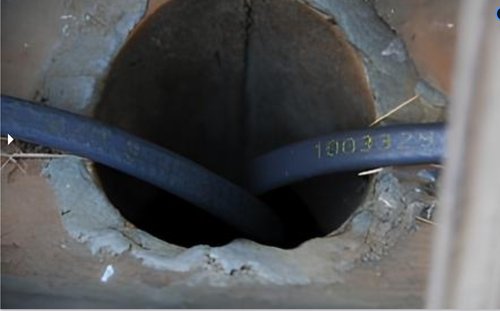 Roof & Gutter Deicing System installing in downspout