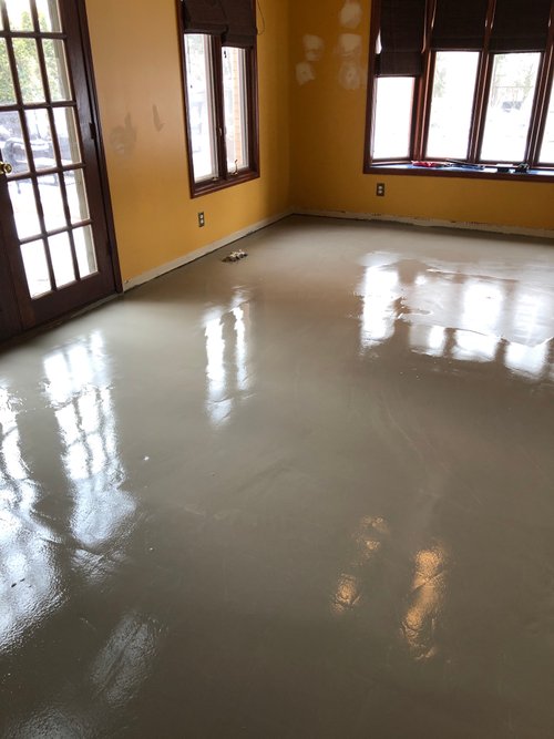 Self-leveling cement poured for living room heated floors