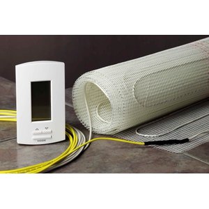 An electric radiant floor heating mat with white fiberglass mesh and heating wire next to a digital thermostat with a MODE button.