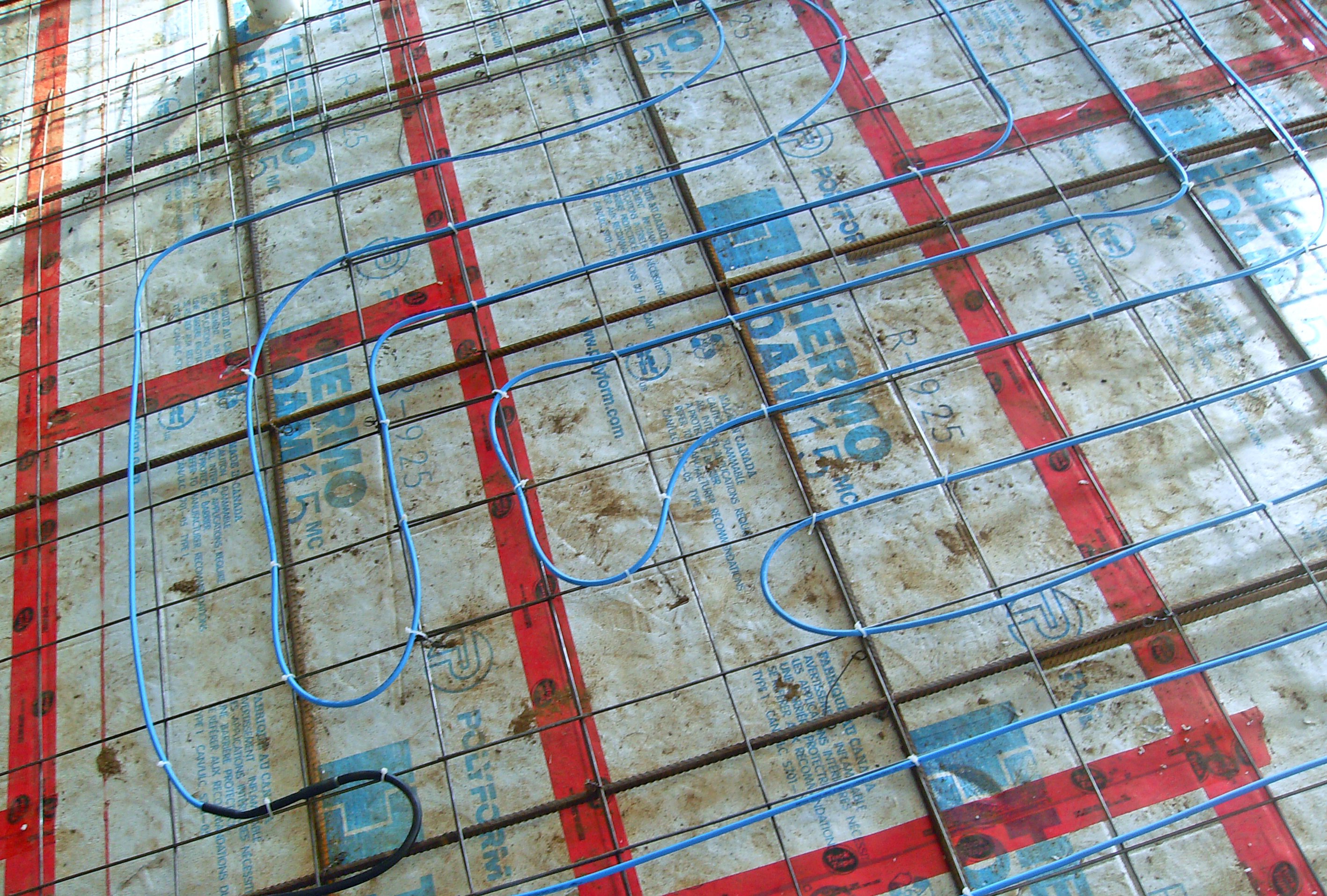 Slab heating systems are installed in freshly poured concrete.