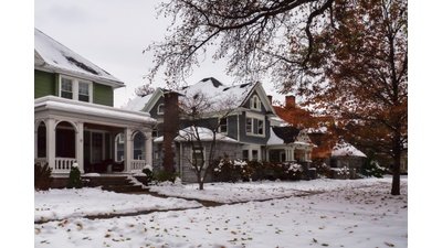 Snow-covered residential home in Rochester, NY during winter
