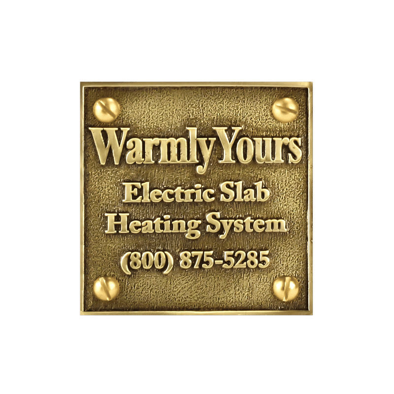 A square WarmlyYours cast brass snow melt plaque with raised lettering for electric slab heating system identification.