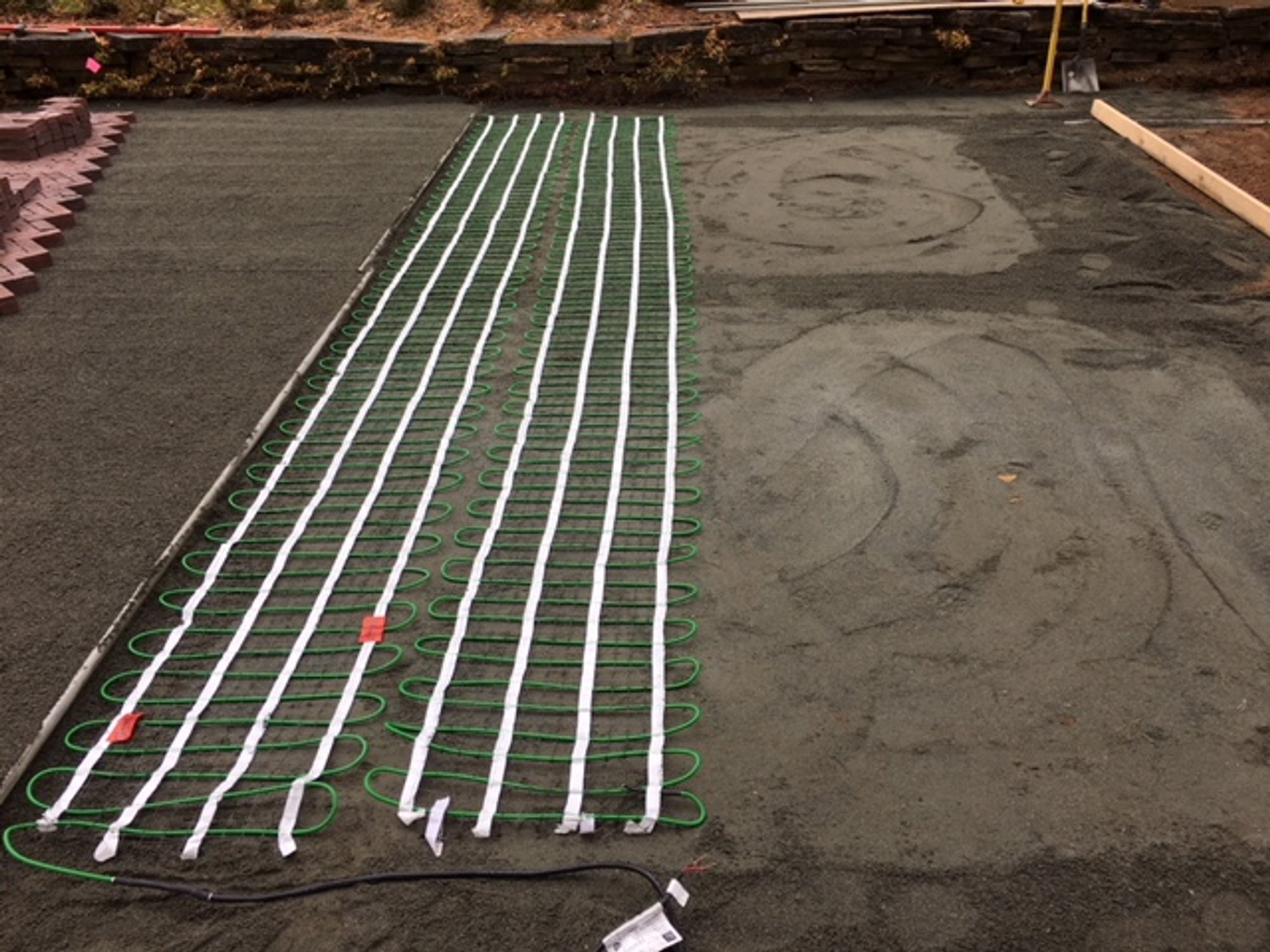 Snow Melting Mats installation embedded in sand under paver driveway