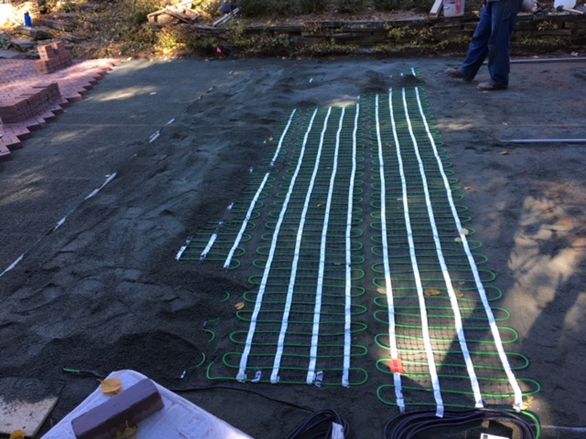 Snow Melting Mats installation embedded in sand under paver driveway