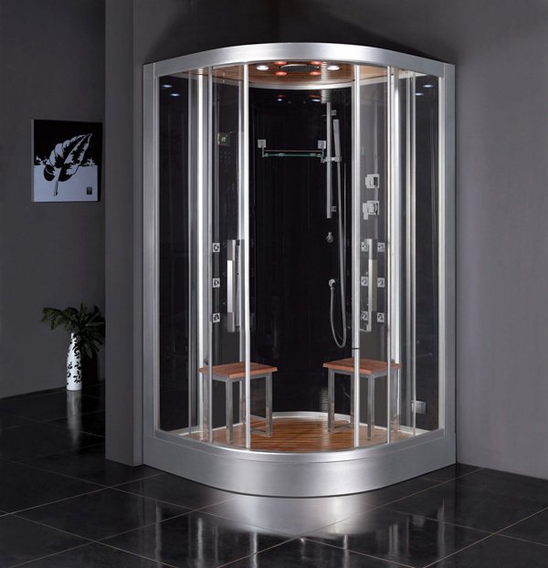 A freestanding corner steam shower enclosure with a curved glass front, slatted wood interior, and integrated body jets on a black tiled floor.