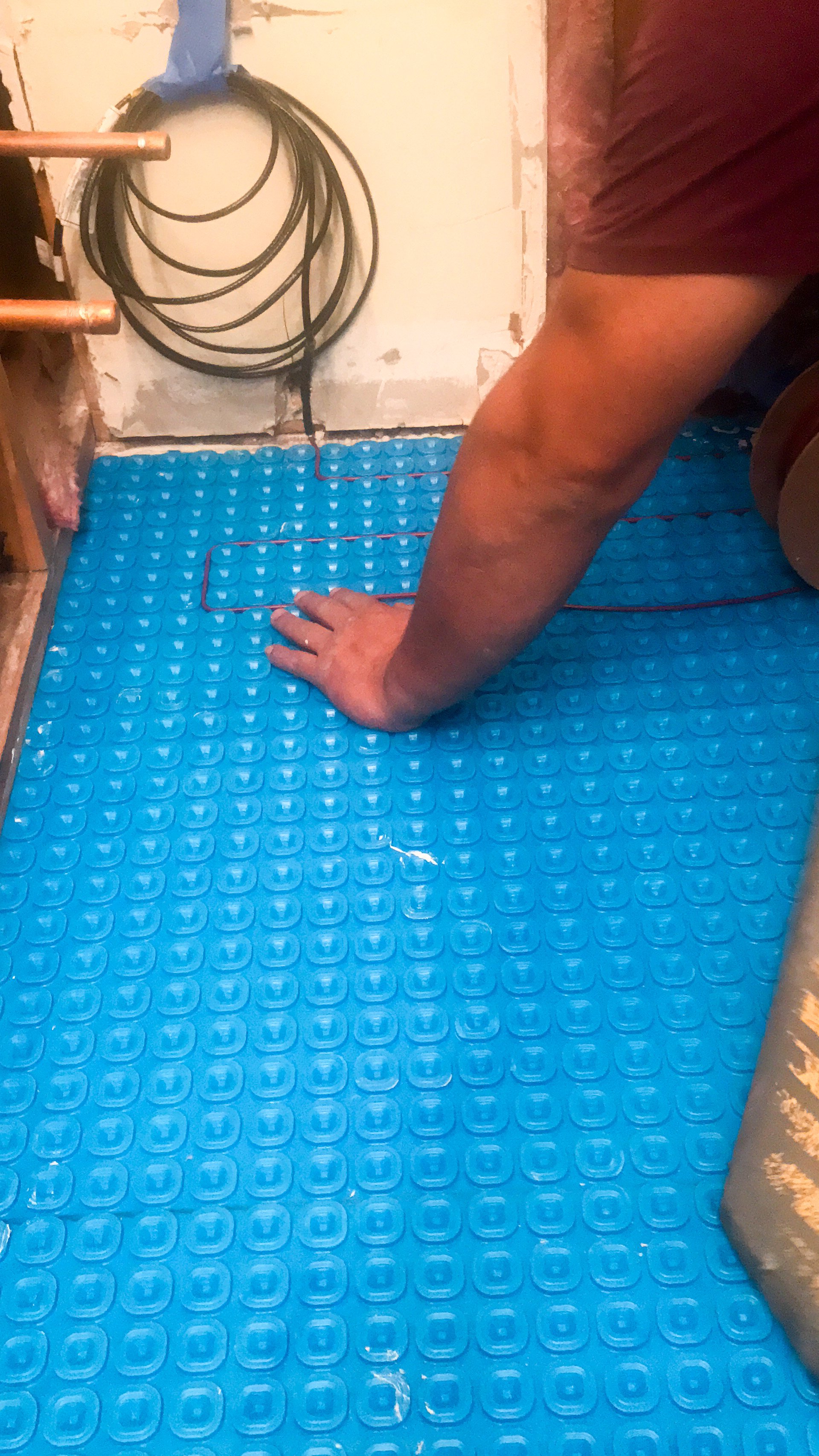 TempZone heating cable installed over blue Prodeso uncoupling membrane