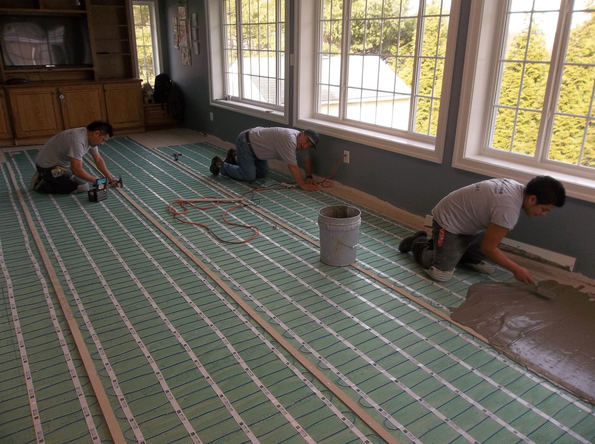 TempZone Flex Rolls being installed under thinset for family room