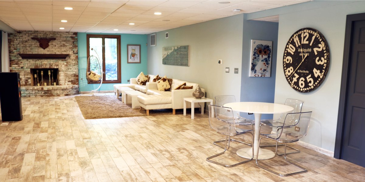 Finished basement living area with wood-look tile flooring installed over an electric radiant floor heating system.