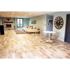 Finished basement living area with wood-look tile flooring installed over an electric radiant floor heating system.