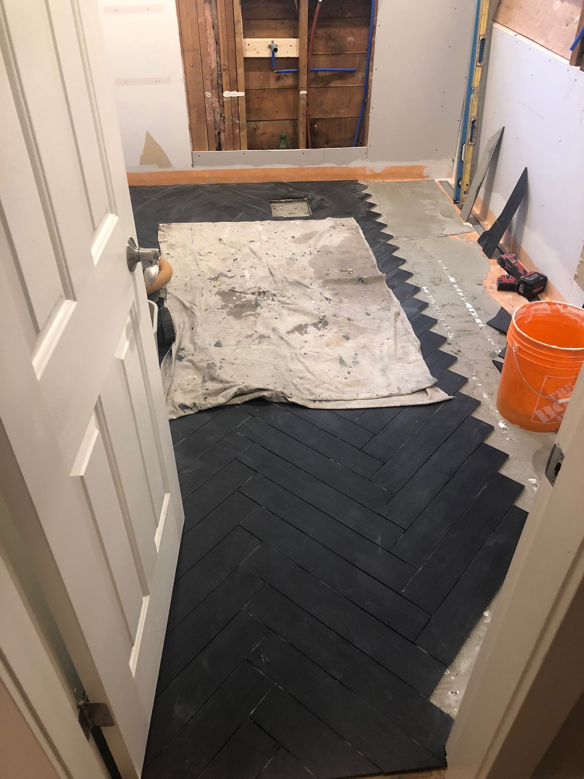 Tile floor installation with electric floor heating mats for bathroom remodel