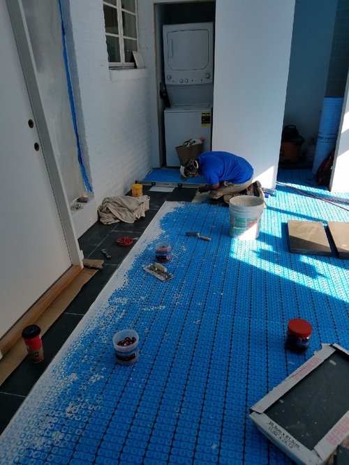 Tile floor installation with uncoupling membrane and electric floor heating cable ALEXANDRIA, VA
