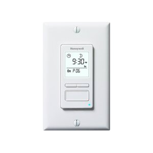 Honeywell programmable timer switch for towel warmers with an LCD display showing time and settings mounted on a white wall plate.