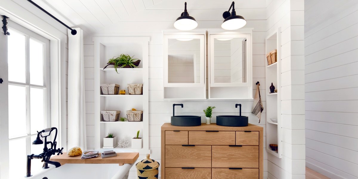 Underfloor heating installed in a tile bathroom with vanity, mirrors and tub.