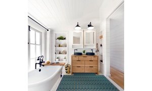 Underfloor heating installed in a tile bathroom with vanity, mirrors and tub.