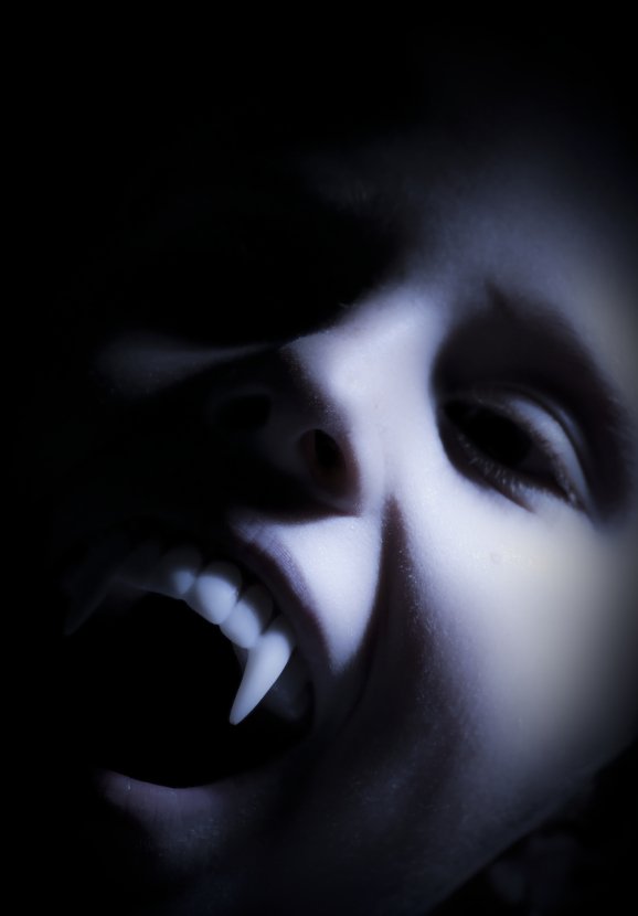 A close-up portrait of a vampire with pointed fangs, illustrating the concept of energy efficiency in radiant heating systems.