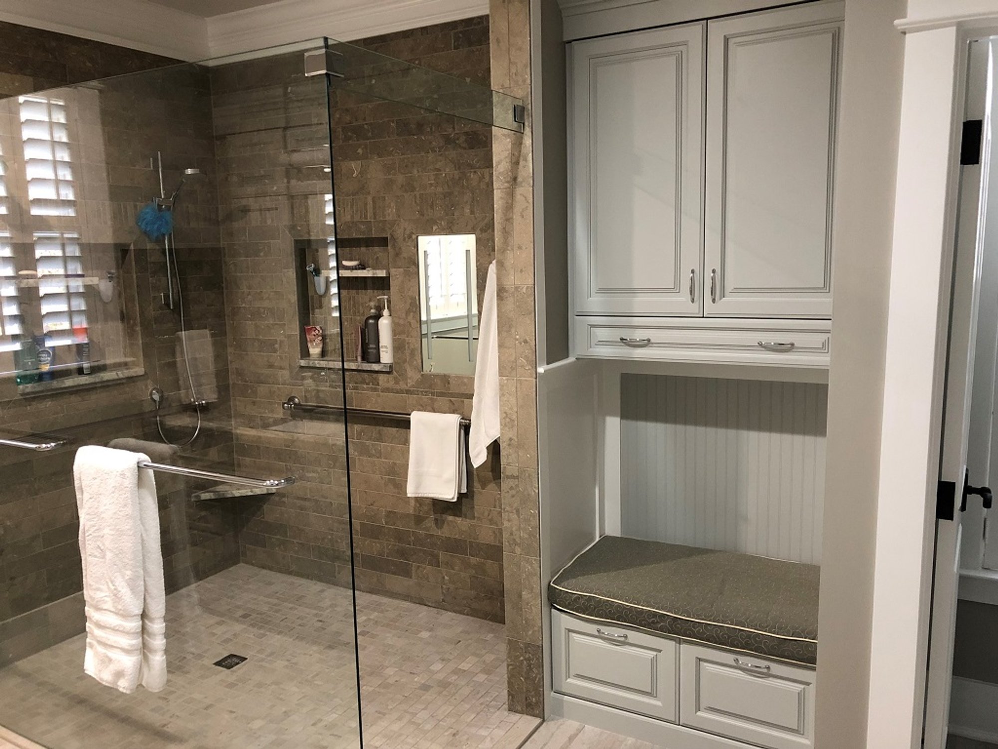 Walk-in curbless shower with heated tile floor by Winslow Design Studio