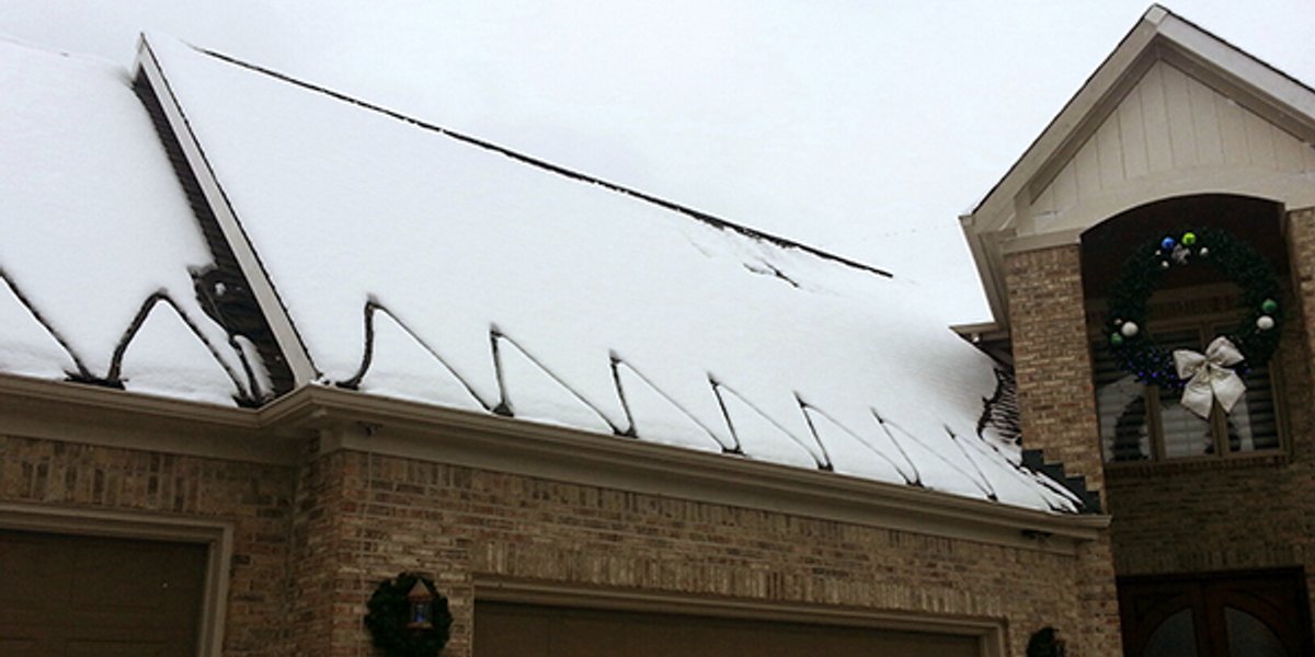 Roof and gutter deicing cable on veterans' home porch roof