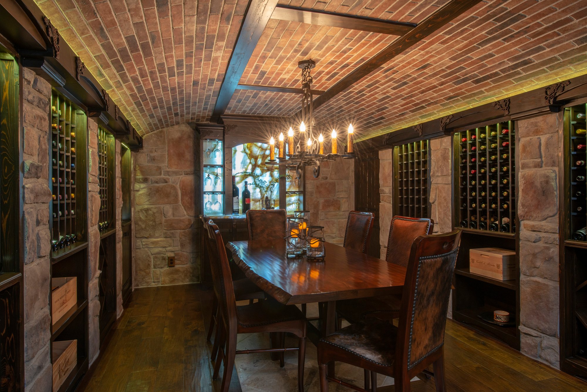 Wine cellar dining room with heated flooring by Architectural Justice