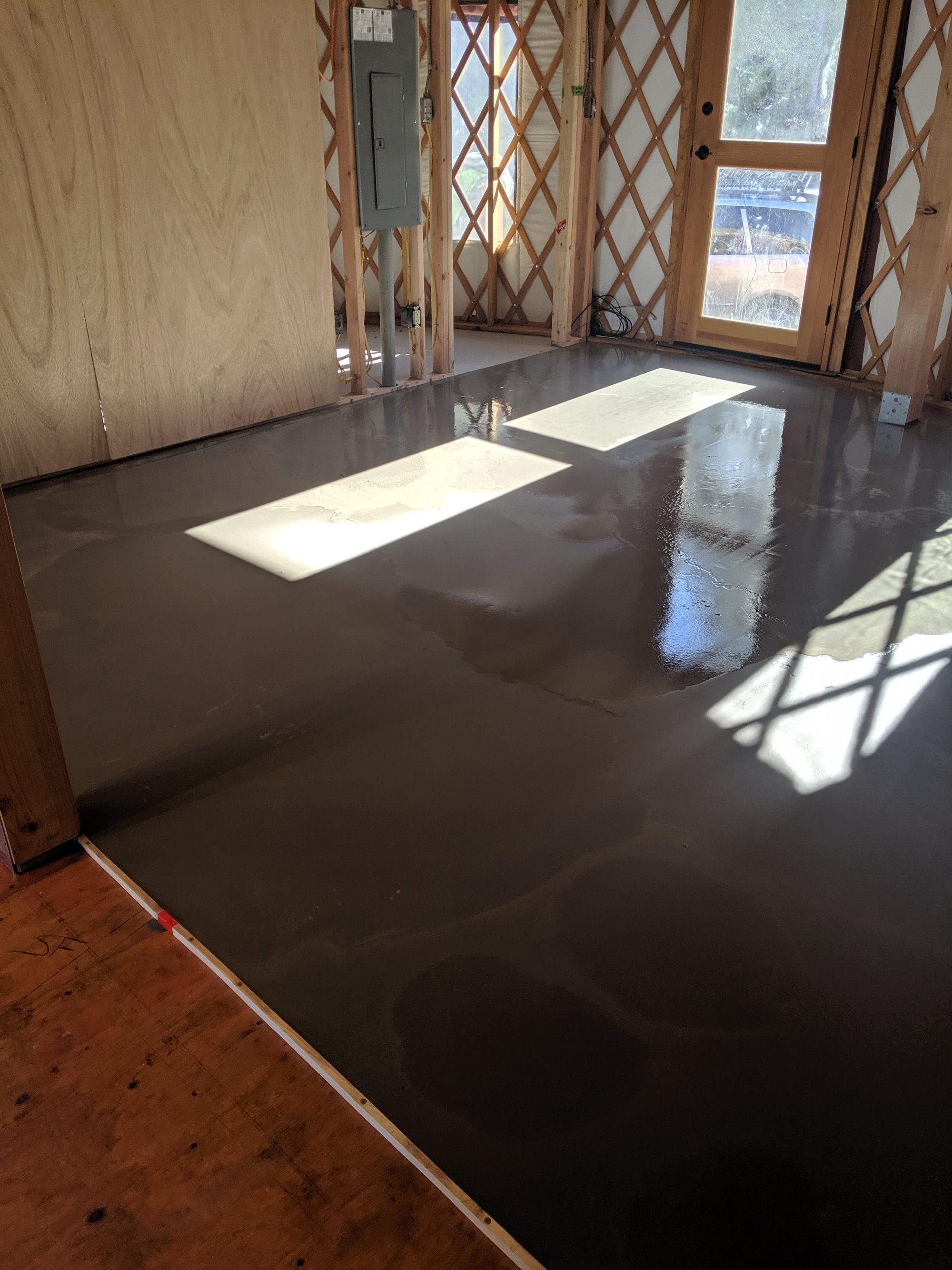 Yurt floor heating project self leveling cement step completed