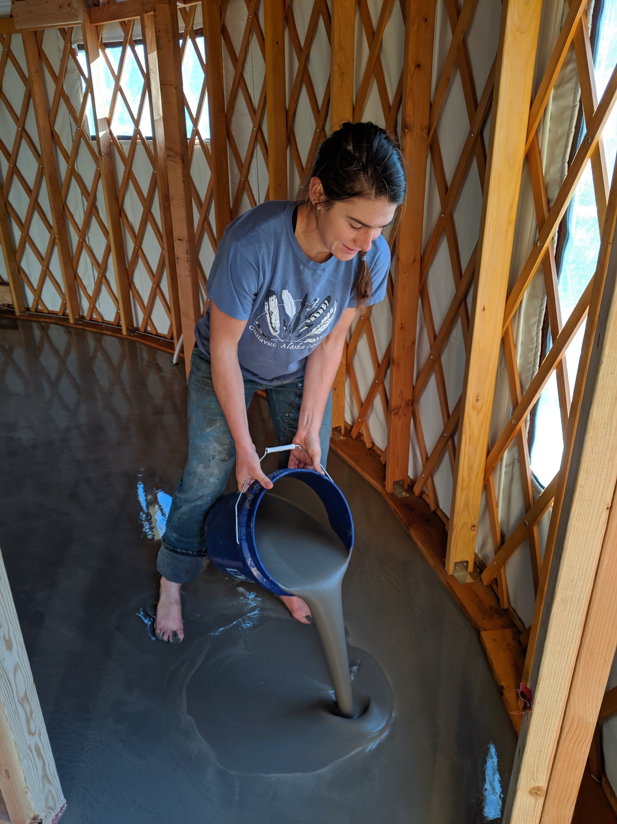 Yurt floor heating project with katie pouring self leveling cement