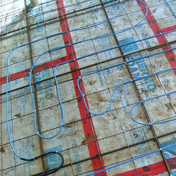 Slab heating systems are installed in freshly poured concrete.