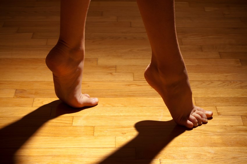 Female Bare Feet Hardwood Floor Shadow Stock Photo