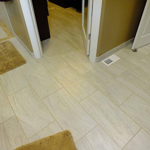 Porcelain tile in the master bath suite became warm and inviting with electric radiant floor heating