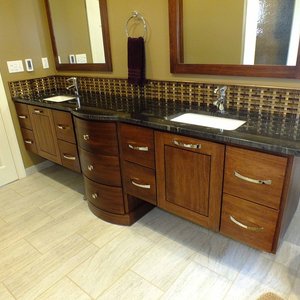 Asian influenced vanity and backsplash complement the luxurious radiant heated porcelain tile flooring in this master bath suite