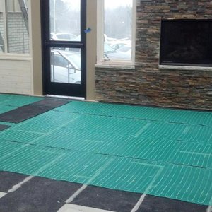 Installing CeraZorb synthetic cork underlayment under the TempZone floor heating system prevents heat loss through the concrete below, allowing more heat to radiate into the room.