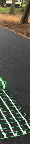 Dry-fitting Snow Melt Mats on Asphalt Driveway
