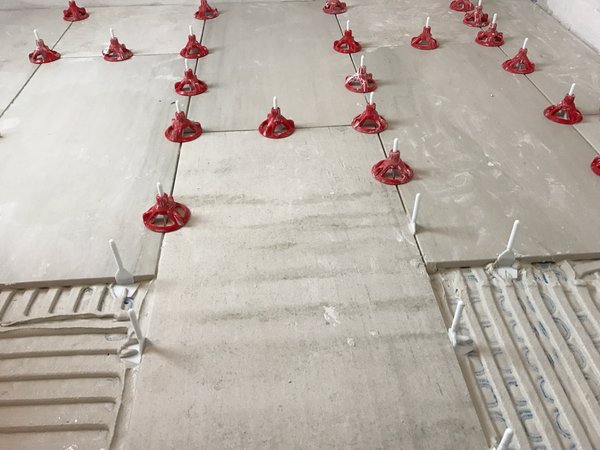 Tile being installed over underfloor heating with thinset