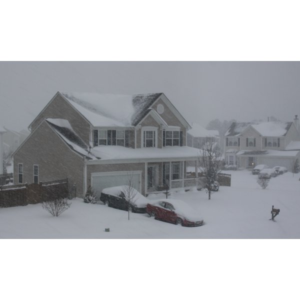 Cars in snowy driveway