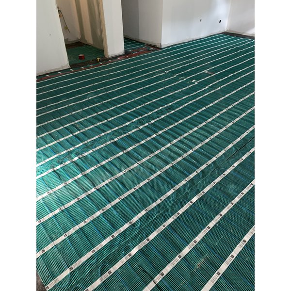Floor heating rolls being installed in a basement