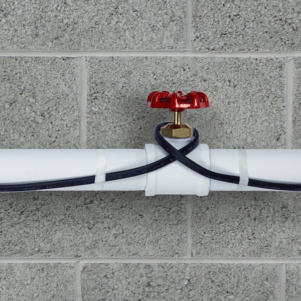 Self regulating pipe freeze protection heating cable installed on plastic pipe