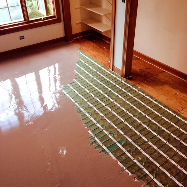 How to Self Level Bathroom Floors Part 2Adding Leveler Over Concrete --  by Home Repair Tutor 