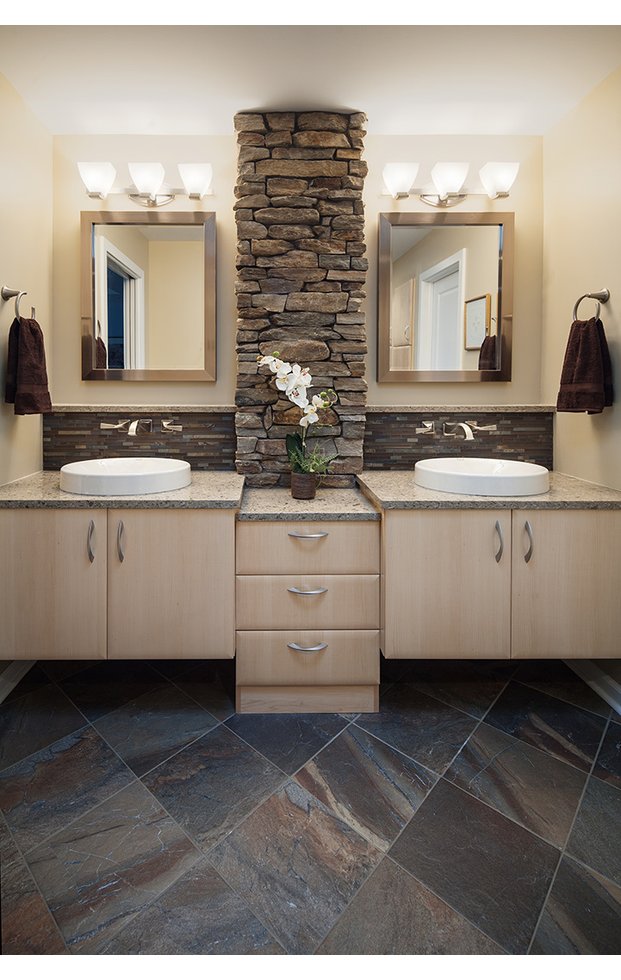 Two sink bathroom with stone pillar